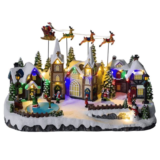 Villaggio di Natale innevato decorativo con luci